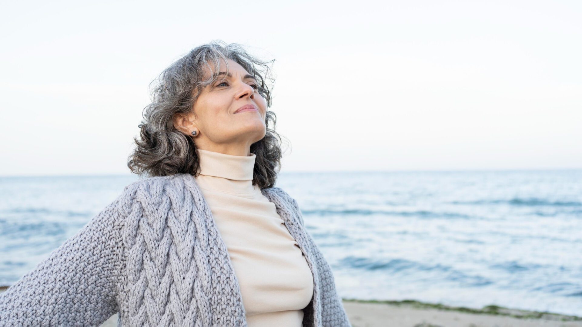 beautiful-senior-woman-enjoying-her-time-beach senior woman enjoying her time at the beach